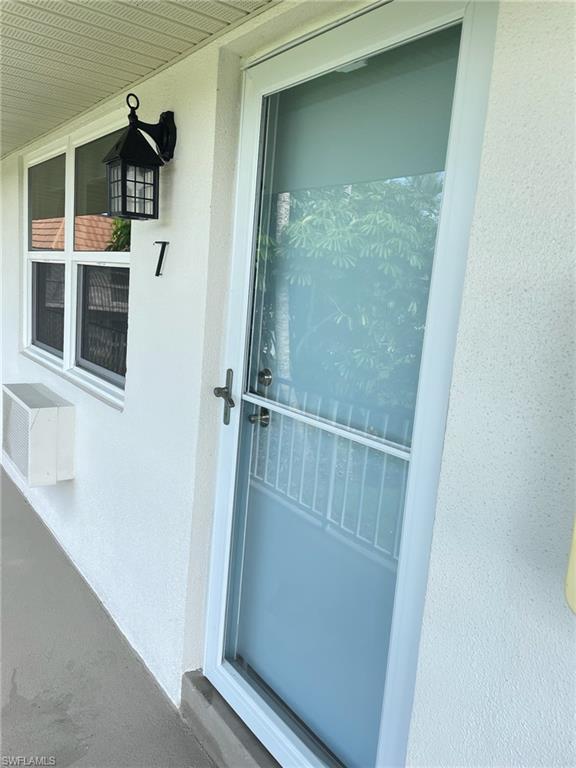 Entryway featuring a white impact windows and entry door