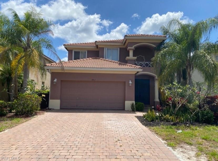 Mediterranean-inspired stucco exterior featuring a barrel tile roof