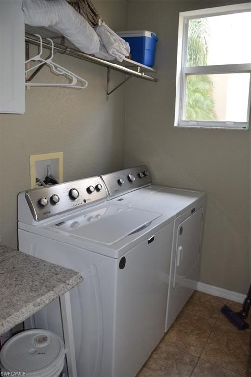 Dedicated laundry space featuring a white top-load washer and dryer set, a single-pane window, and a wall-mounted shelving unit with a hanging rod