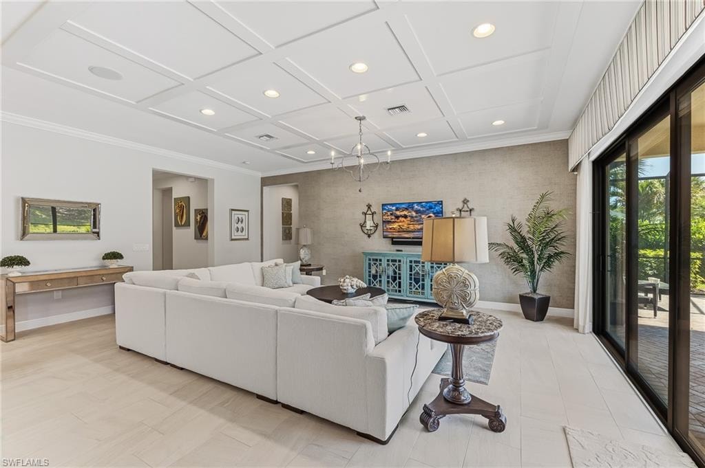Living space featuring coffered ceilings with recessed lighting, light-toned tile flooring, and a textured accent wall