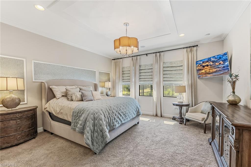 Spacious bedroom featuring neutral wall tones and plush carpeting