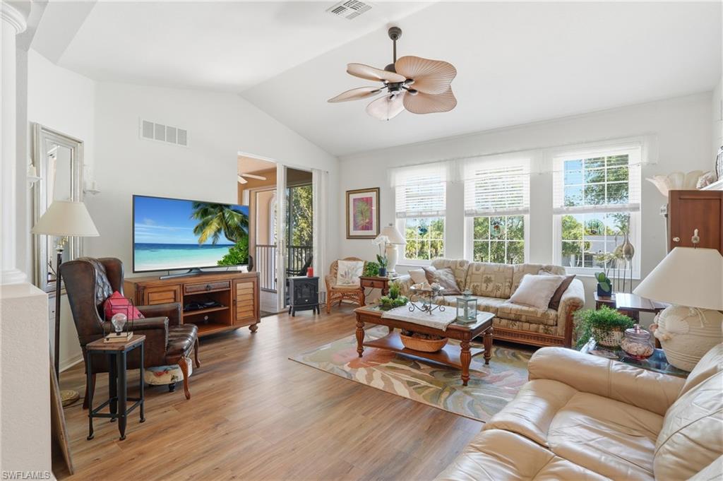 Light and airy family room with cathedral ceingand ceiling fan