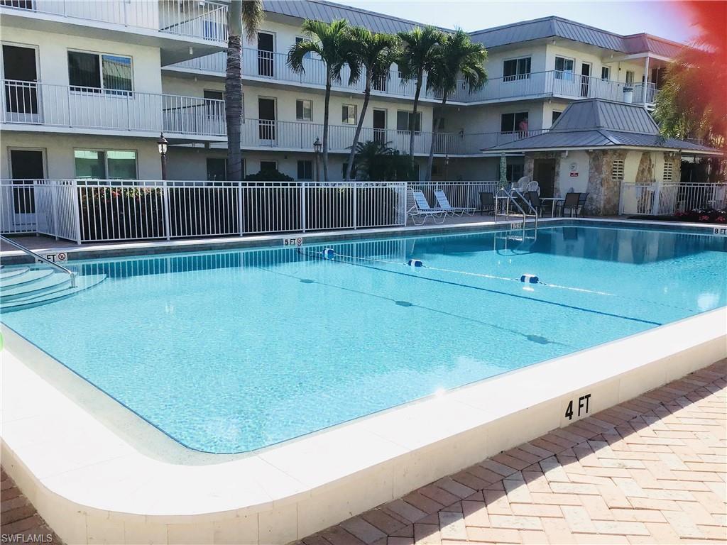 Pool area has plenty of seating tables, and lounge chairs
