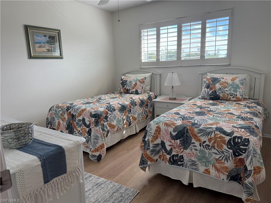 Bedroom with wood finished floors and a ceiling fan