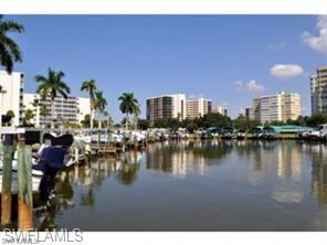 Water view with nearby urban area and a boat dock