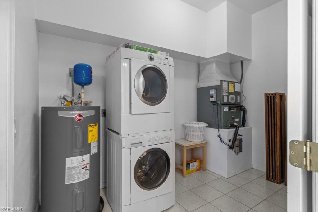 Dedicated utility area featuring a stackable washer and dryer, water heater, and furnace