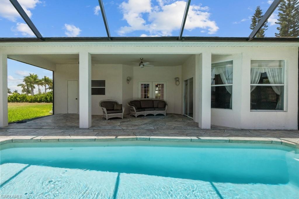 Outdoor screened-in pool area featuring a rectangular pool and an expansive covered patio