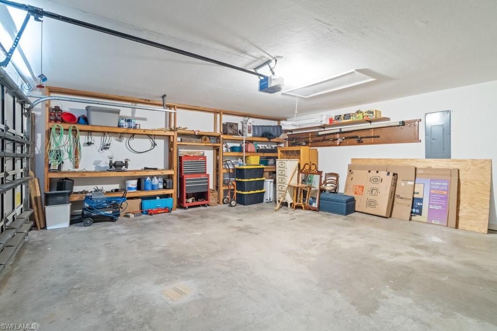 Spacious garage featuring concrete flooring and built-in shelving