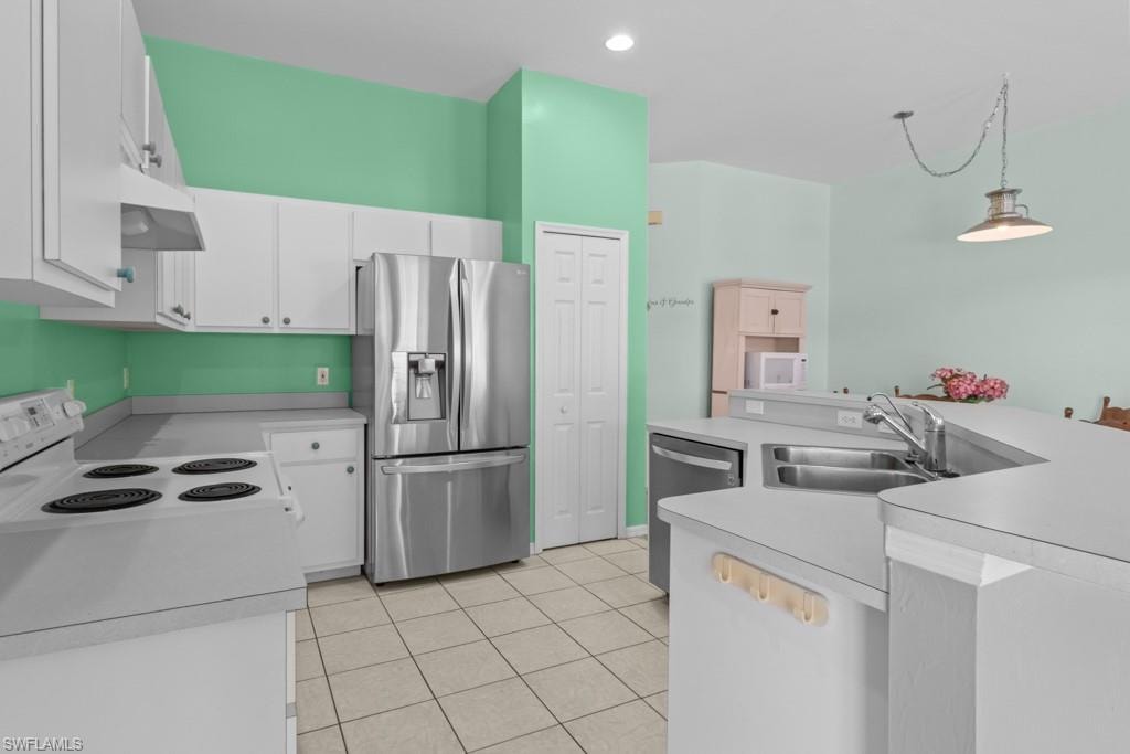Open kitchen featuring white cabinetry, a stainless steel French door refrigerator, a dual-basin sink, and tile flooring