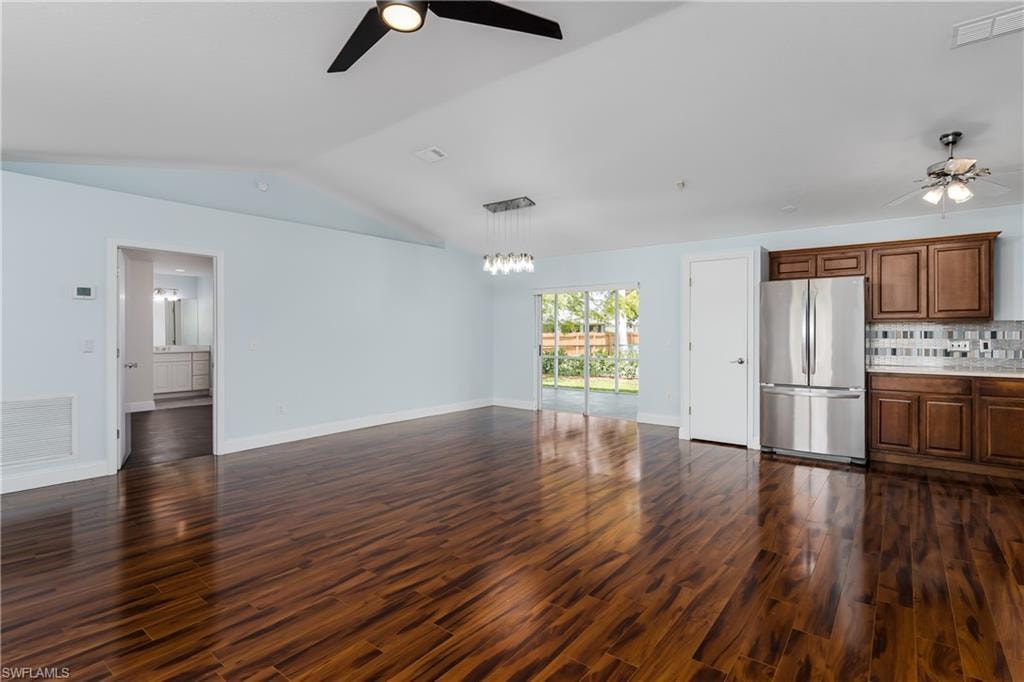 Spacious interior with vaulted ceilings and wood-finish flooring
