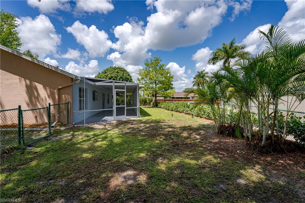 The property features a screened-in patio with a concrete floor, offering an outdoor living space