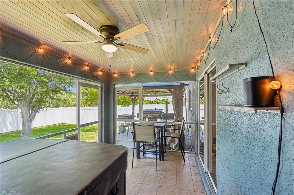 Screened porch featuring a wood-finish plank ceiling and tile flooring