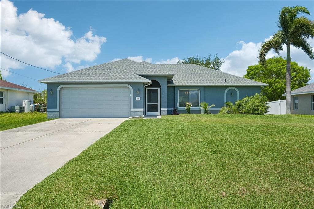 Contemporary single-story residence featuring a two-car garage, a concrete driveway, and a screened entry