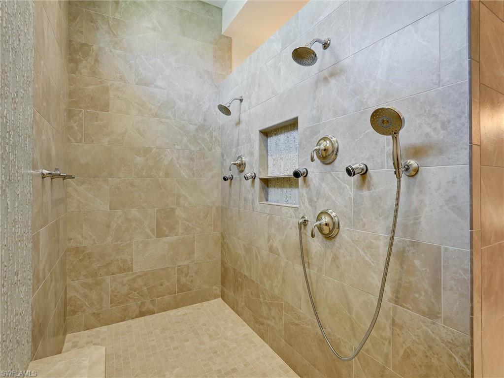 Huge walk in shower with designer tile work & dual shower heads