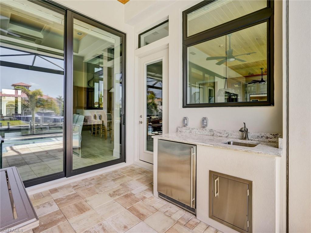 Convenient counter, "fridge" & storage for the lanai, beautifully finished  with granite