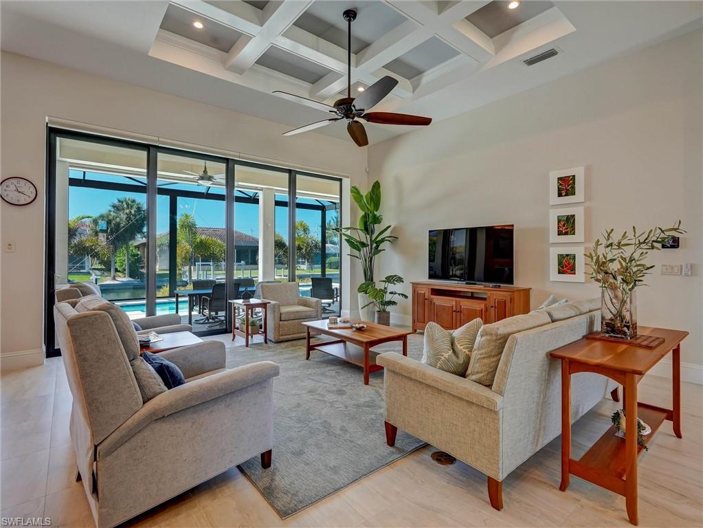 Sunshine in your great room looking out to the Lanai. Note the box beam ceiling & 10' slider