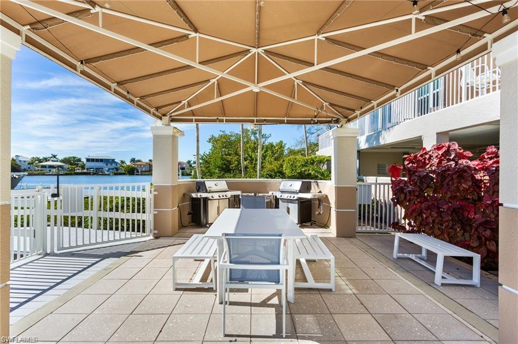 Covered BBQ area with tables.