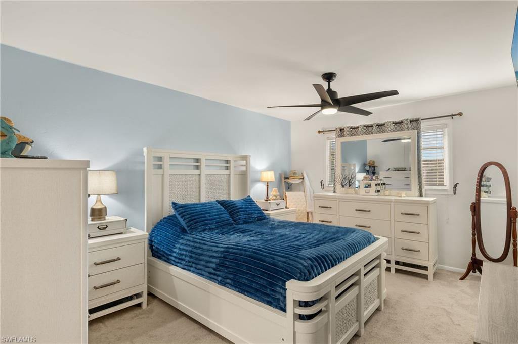 Bedroom featuring light carpet and a ceiling fan