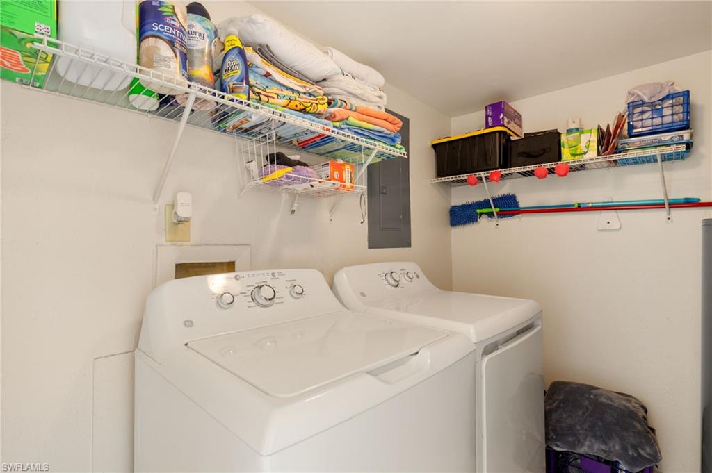 Washroom featuring washing machine and clothes dryer and electric panel
