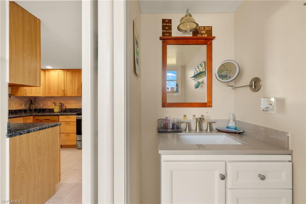 Bathroom with vanity, tile patterned floors, and decorative backsplash