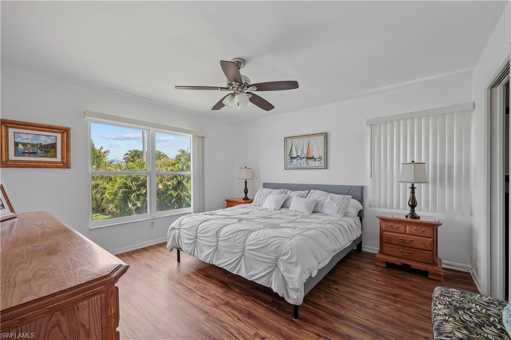 King bed in owner's suite, lake view, and there is a slider to the lanai