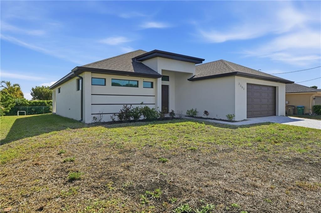 Contemporary stucco exterior featuring a dark brown garage door, dark trim accents, and a covered entry