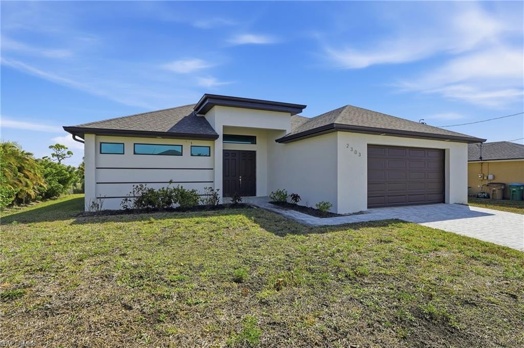 Contemporary stucco exterior featuring a dark brown garage door, dark trim, a covered entry, and horizontal accent windows