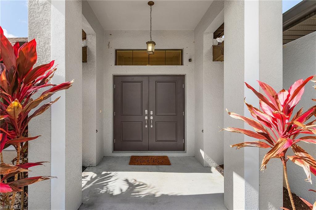 Property entrance featuring stucco siding