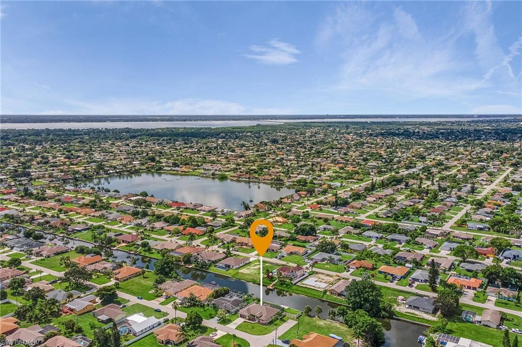 Birds eye view of property featuring a water view and a residential view