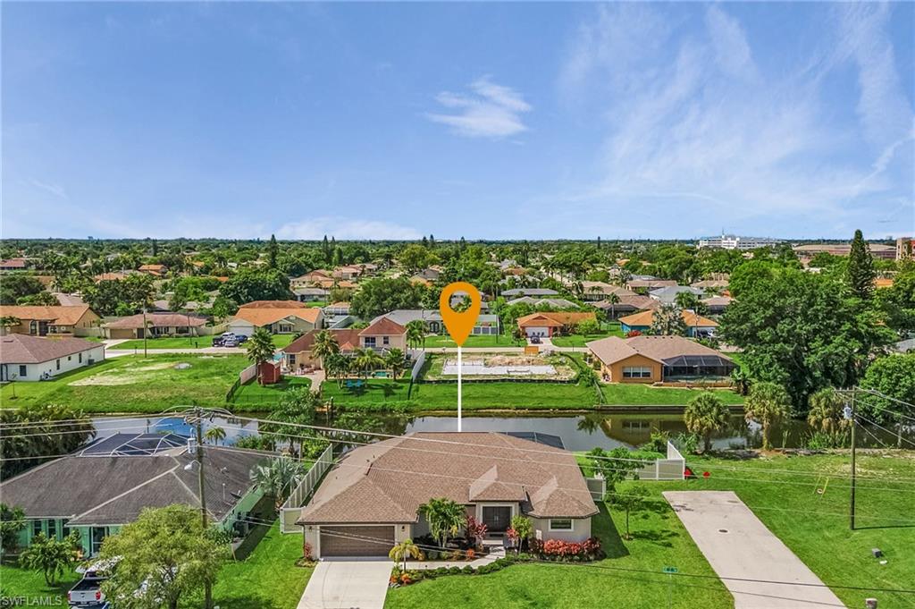 Drone / aerial view with a residential view and a water view