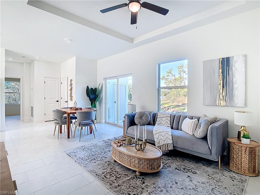 Open-concept living space featuring high ceilings, recessed lighting, and tile flooring