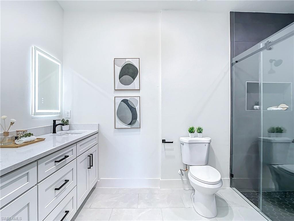Bathroom featuring a white vanity with extensive storage, a rectangular undermount sink, and a black single-handle faucet