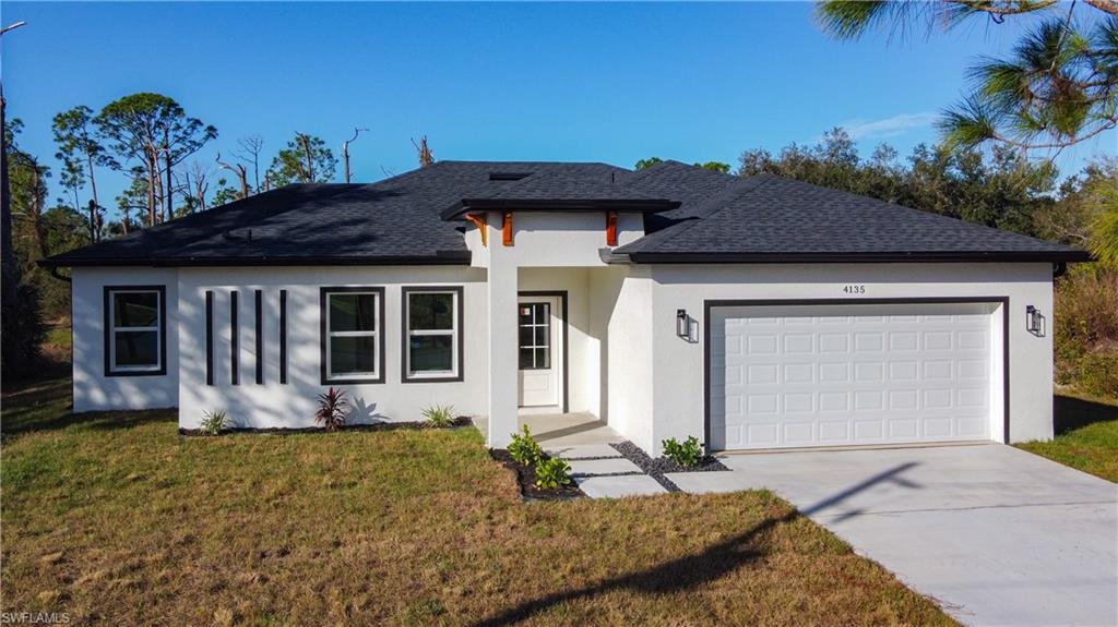 Contemporary stucco exterior featuring a dark asphalt shingle roof and contrasting black-framed windows
