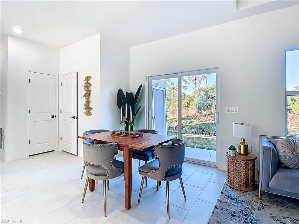Bright interior space featuring white walls and a light-toned tile floor