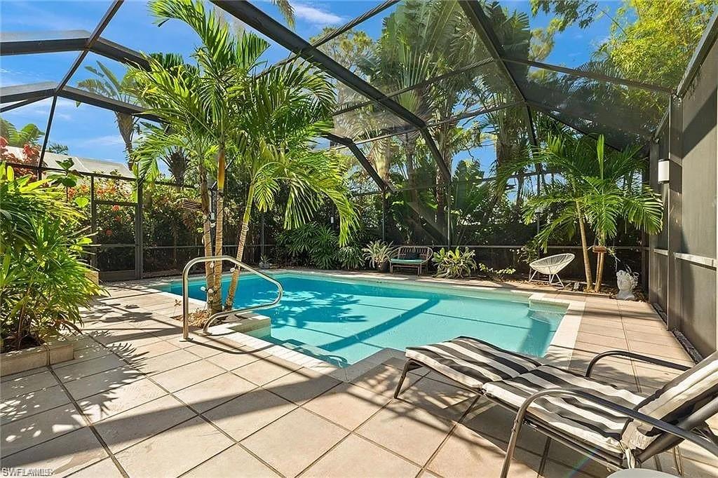 Outdoor pool with a patio area and a lanai