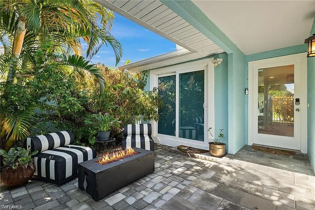 View of patio with an outdoor fire pit