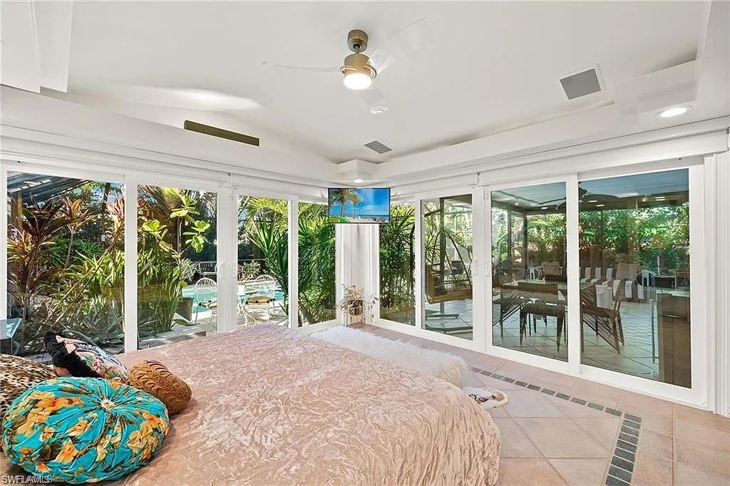 Unfurnished bedroom featuring tile patterned flooring, lofted ceiling, and ceiling fan