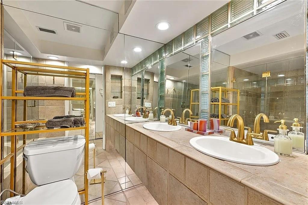 Full bathroom featuring toilet, tile patterned flooring, recessed lighting, double vanity, and an enclosed shower