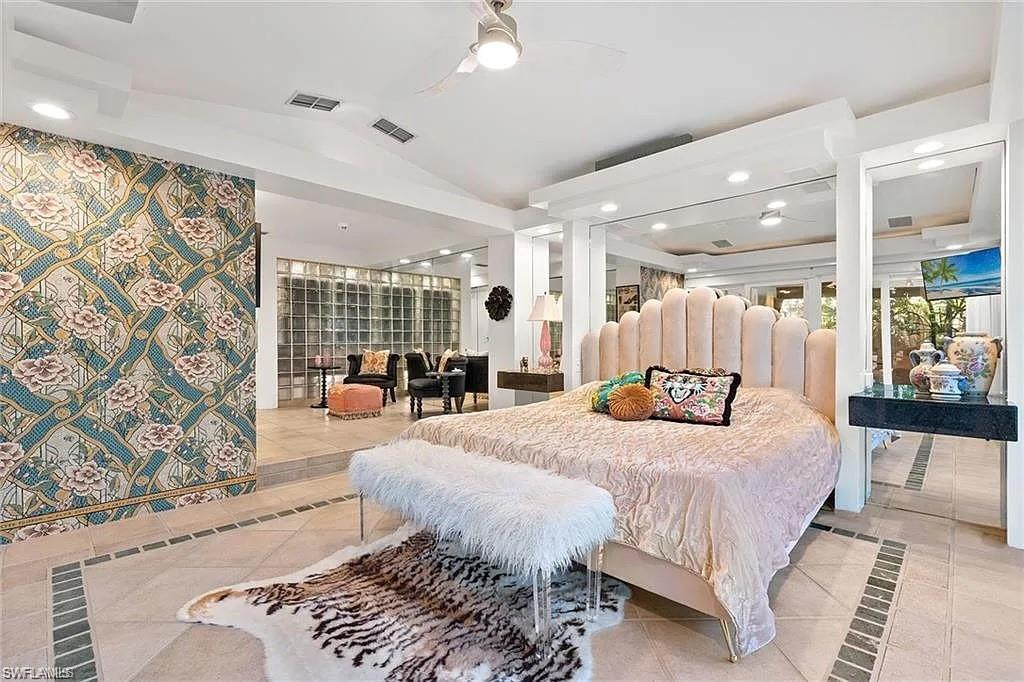 Bedroom featuring light tile patterned floors, inlaid floor details, vaulted ceiling, recessed lighting, and a ceiling fan