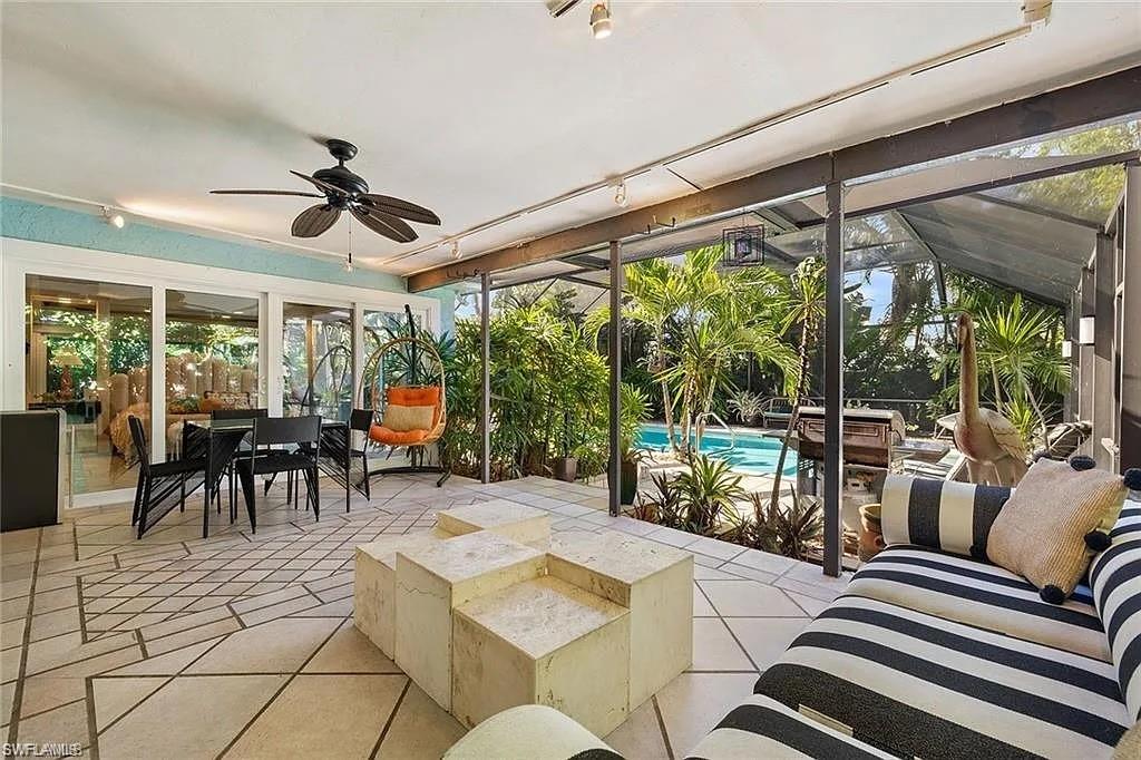 Sunroom / solarium featuring ceiling fan and track lighting