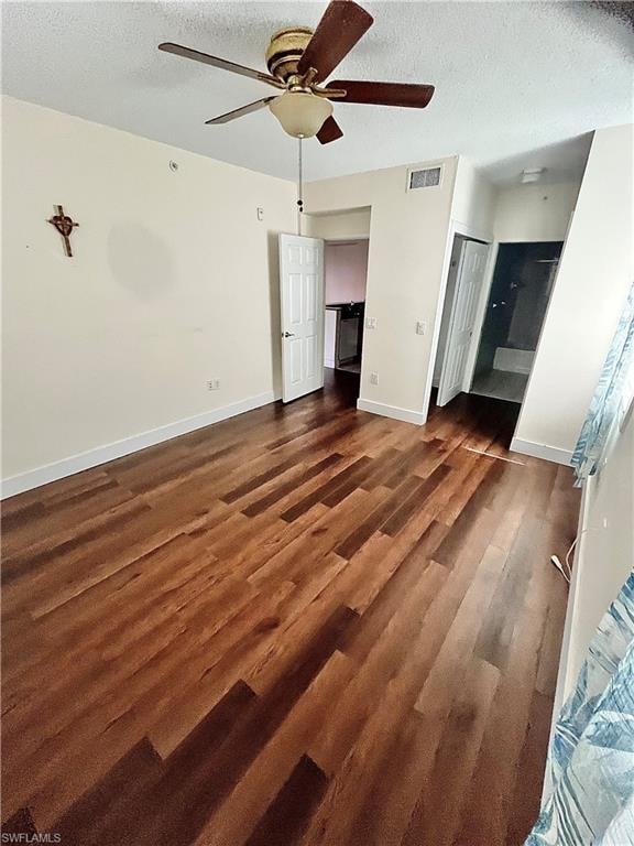 Spacious interior featuring wood-finish flooring, a ceiling fan with light fixture, and white trim