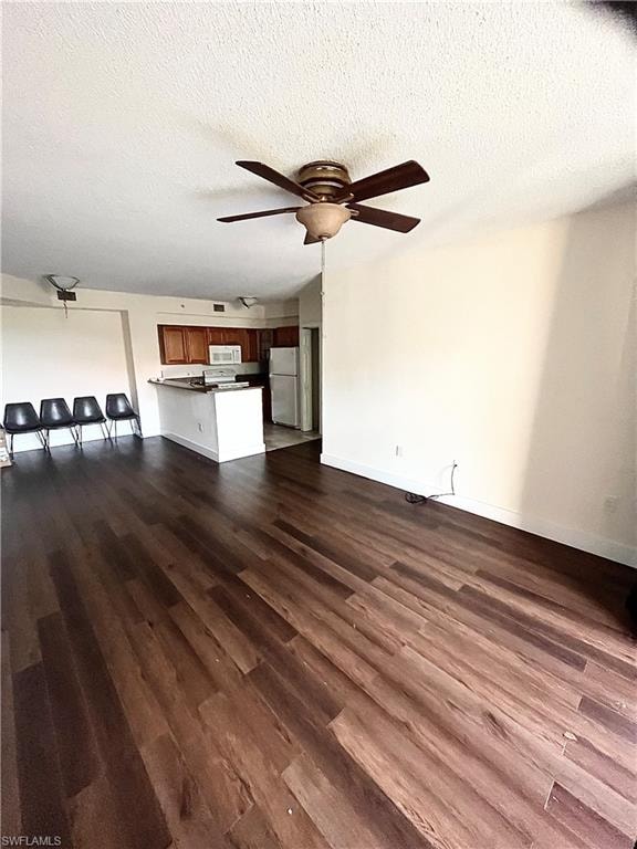 Open-concept living area featuring wood-finish flooring and a ceiling fan