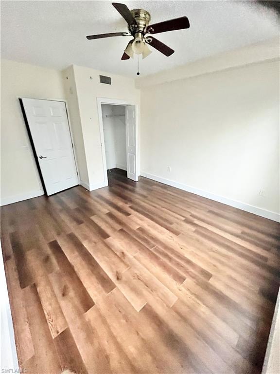 Bright interior space featuring wood-finish flooring, a ceiling fan with integrated lighting, and a closet with bifold doors
