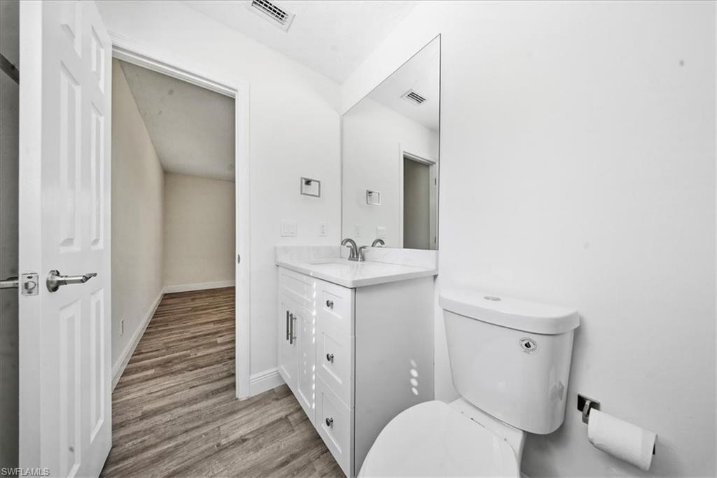 Half bath featuring light wood-type flooring and vanity