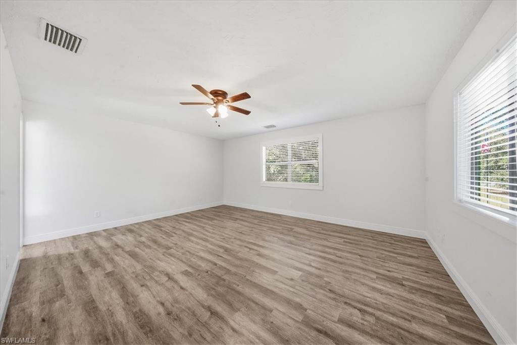Empty room with light wood finished floors and a ceiling fan