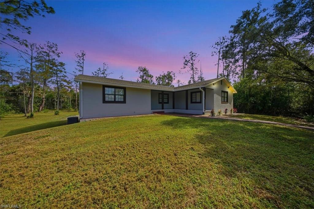 Single story home featuring a front lawn and stucco siding