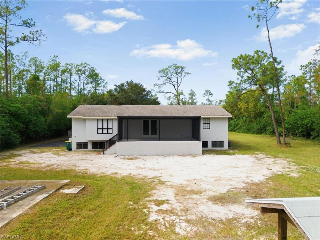 Back of house with a lawn