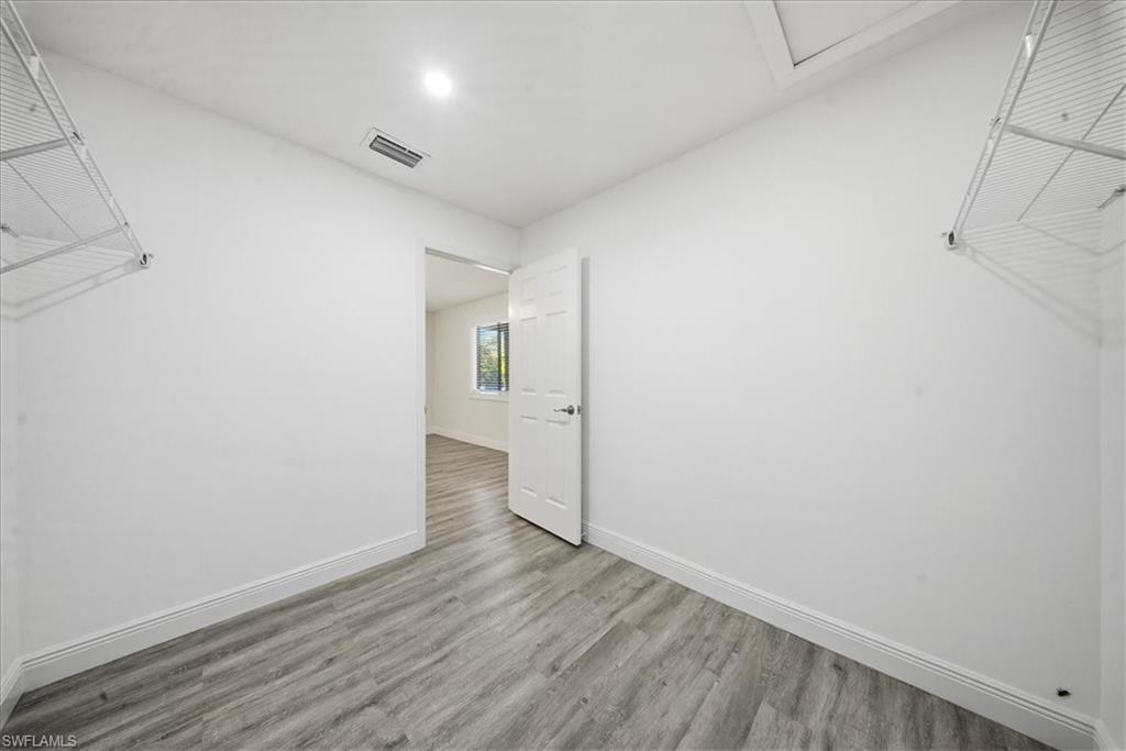Walk in closet featuring wood finished floors