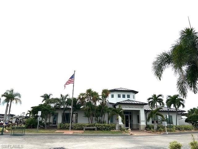 View of front of house with metal roof, a standing seam roof, and stucco siding