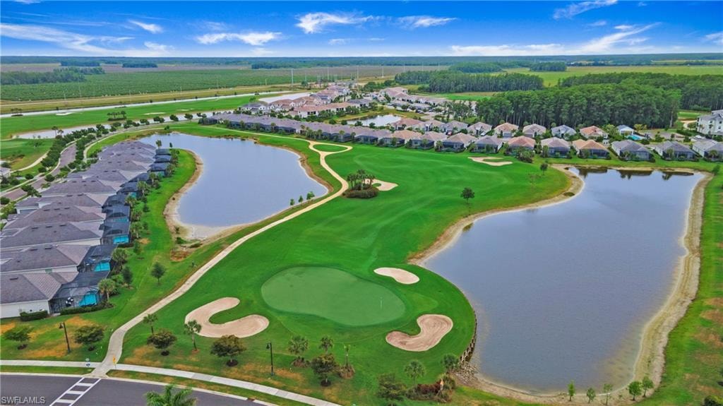 Expansive golf course and lake frontage featuring manicured greens, sand traps, and multiple water features